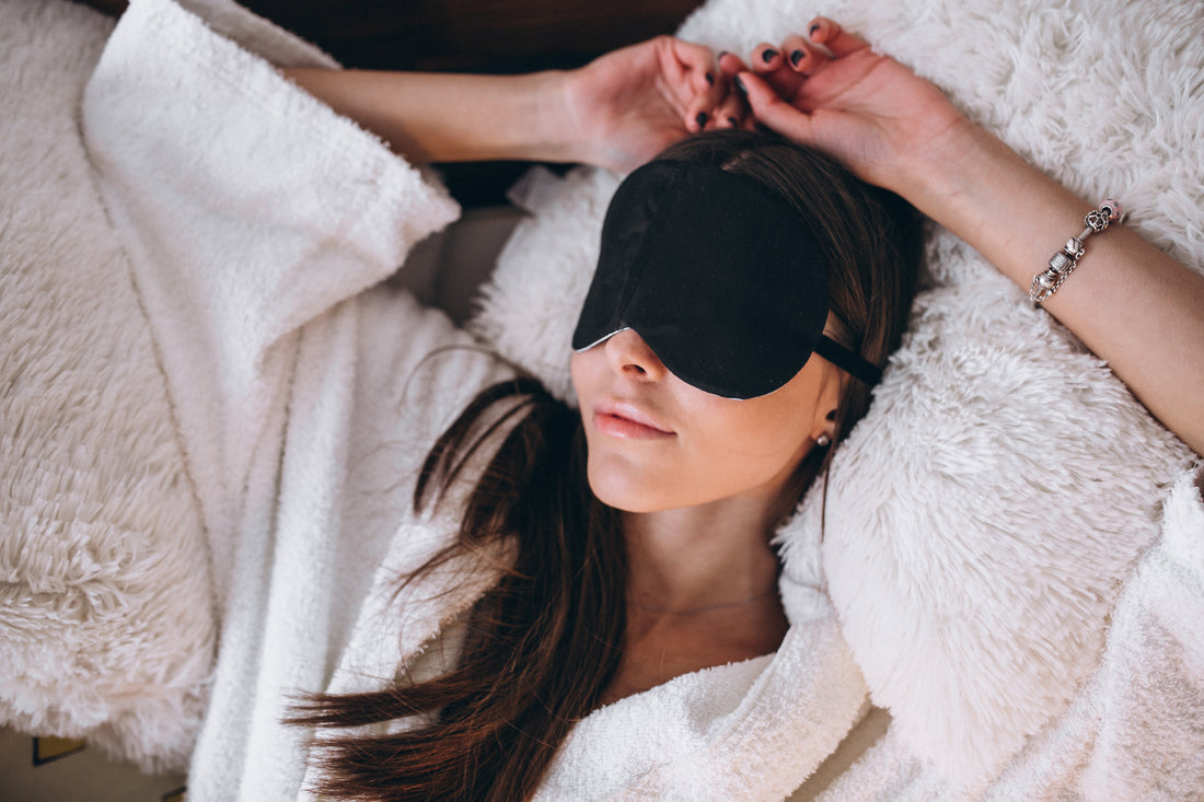 woman bed wearing sleeping mask