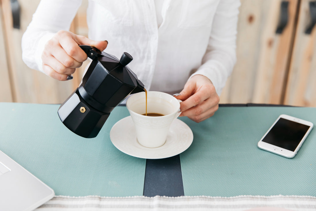 Women pouring coffee into cup
