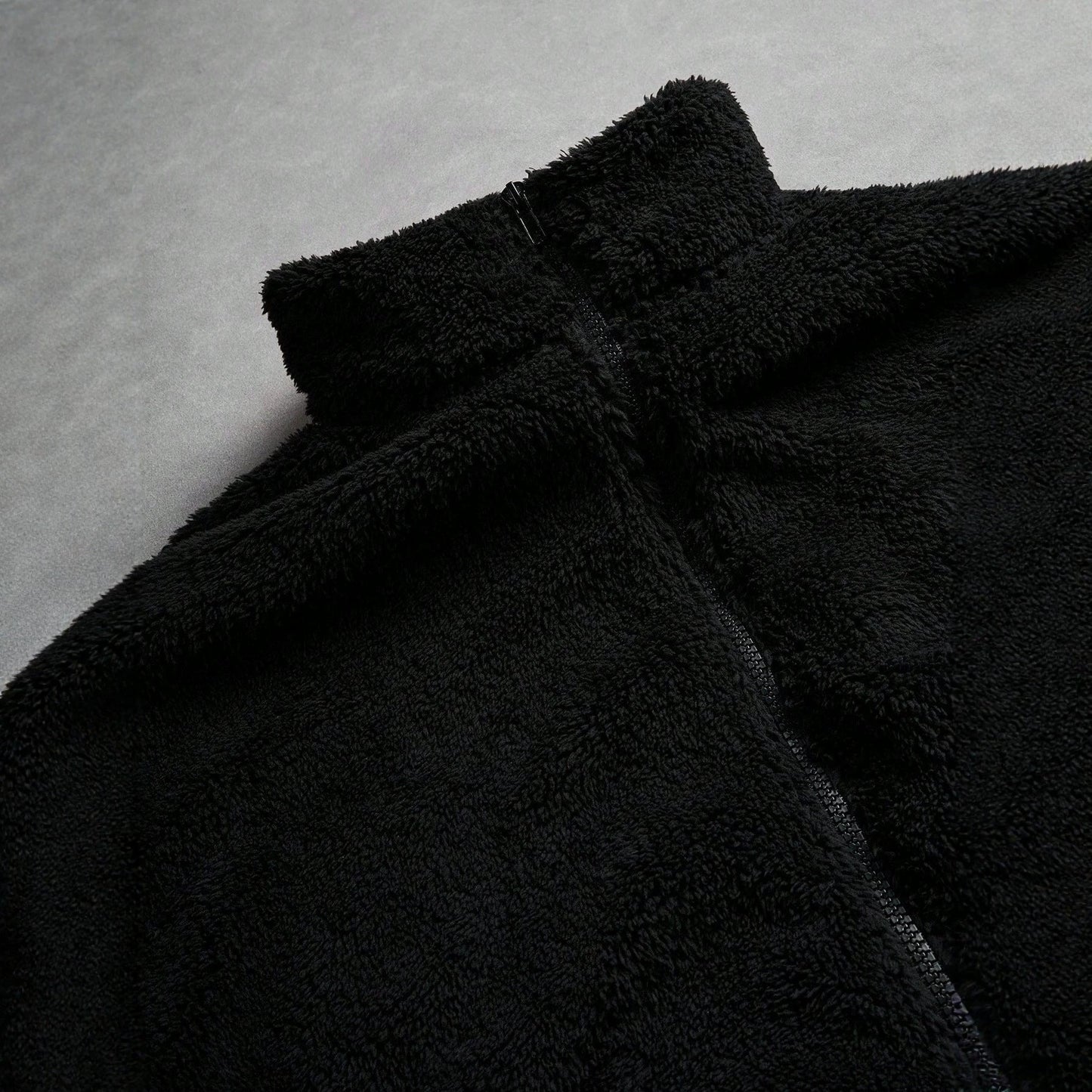 Black Furry Jacket With A Zipper And Embroidery On The Left Chest
